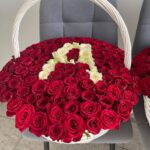 Ваше имя из белых роз на фоне красных роз в больших корзинах